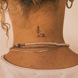 Tatouage tente et arbre
